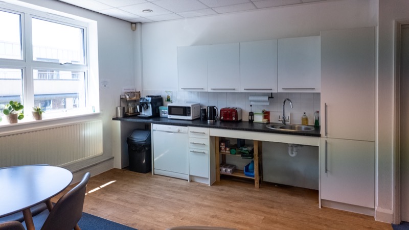 Fitted kitchen and break out area with dining table