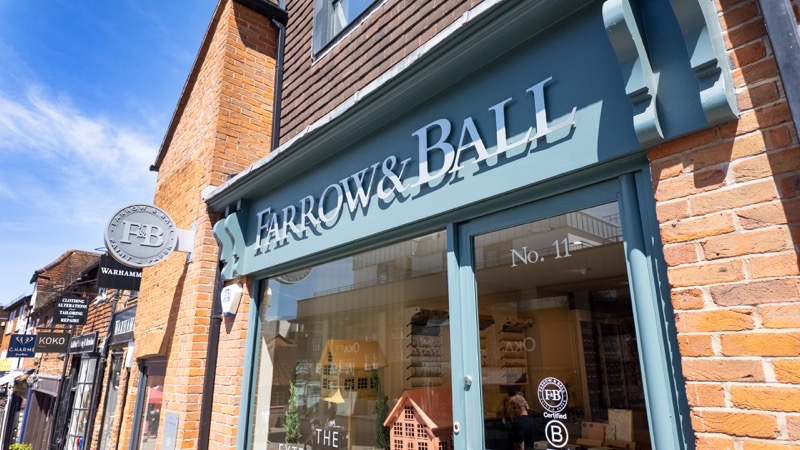 Farrow and Ball paint shop frontage with dark green signage next to Milkhouse Gate